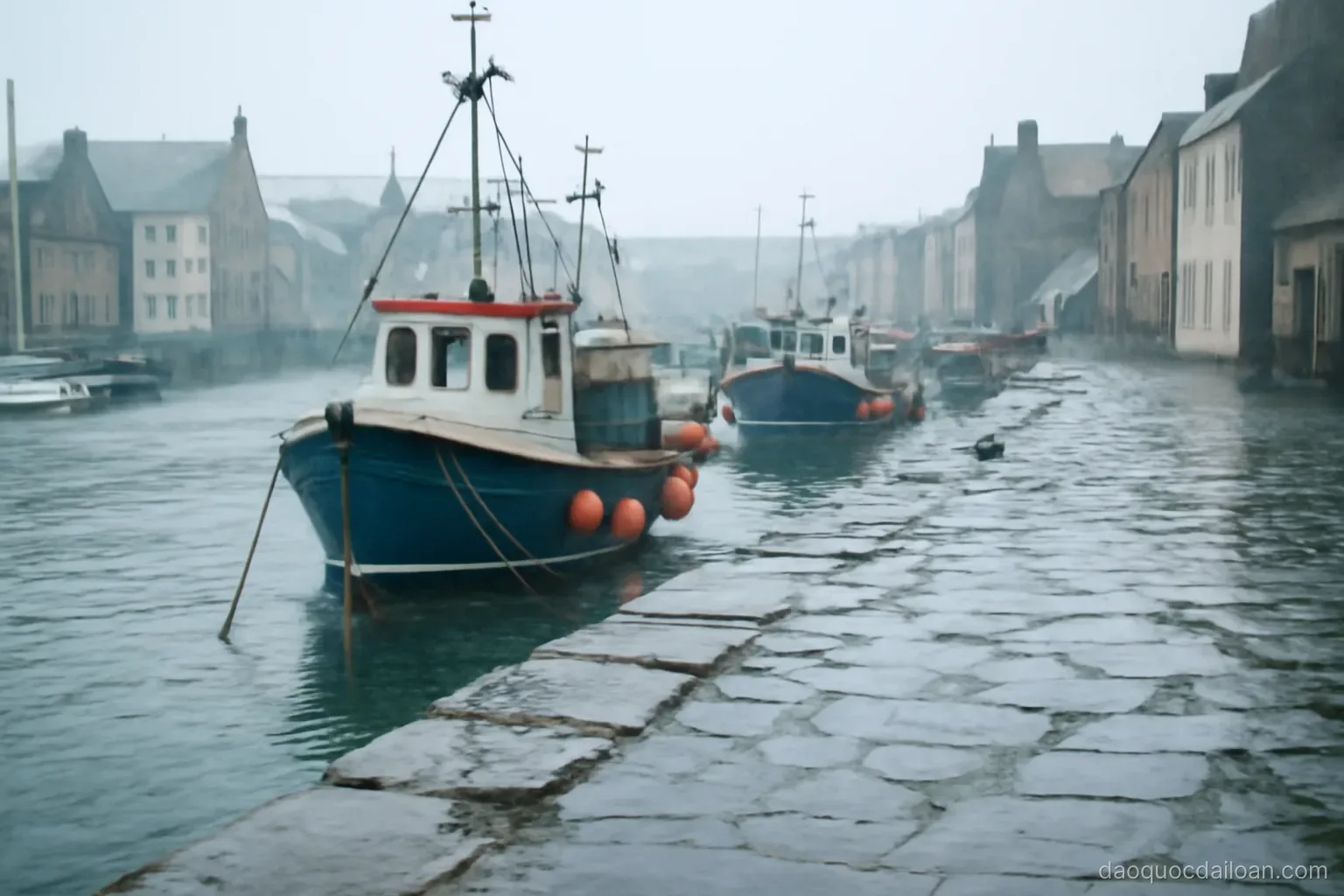 A harbour town under grey drizzle with fishing boats and wet stone quay, no readable text